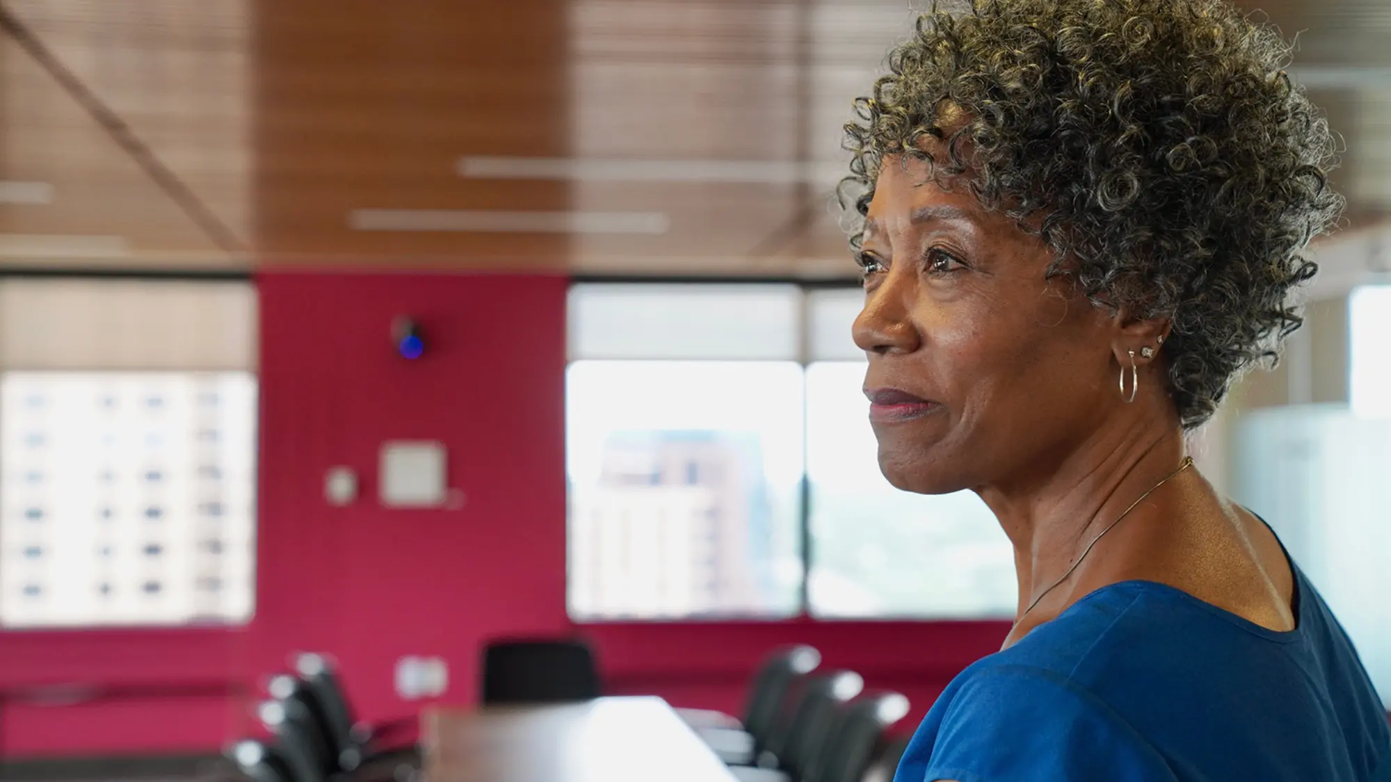 Executive standing in boardroom